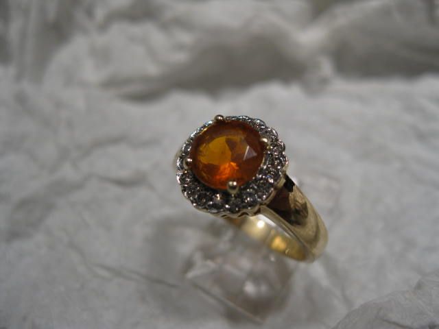 MEXICAN FIRE OPAL SET IN 14 KARAT GOLD WITH A RING OF WHITE DIAMONDS